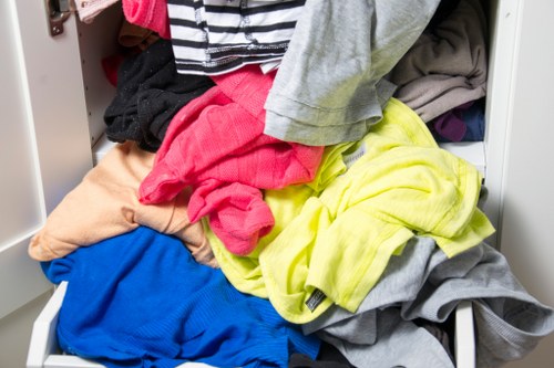 Crew wearing PPE preparing to load green waste into a van