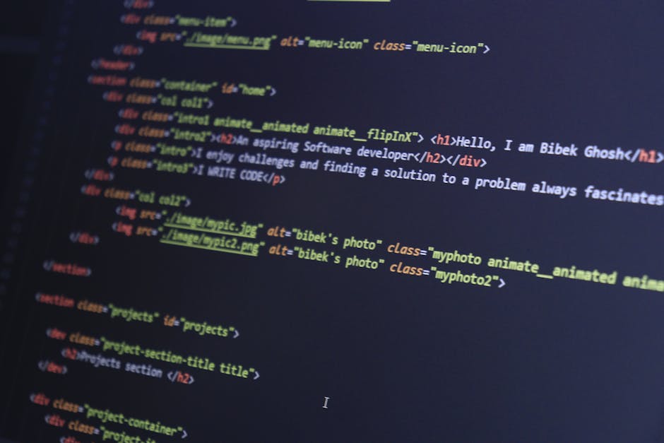 A close-up photograph of a computer screen displaying lines of programming code with syntax highlighting. The code includes multicolored text in shades of orange, pink, green, yellow, and purple on a 